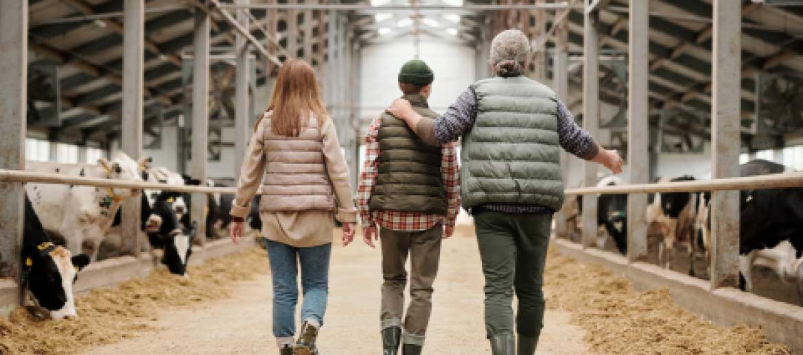 Family walking through farm building