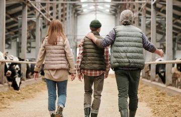 Family walking through farm building